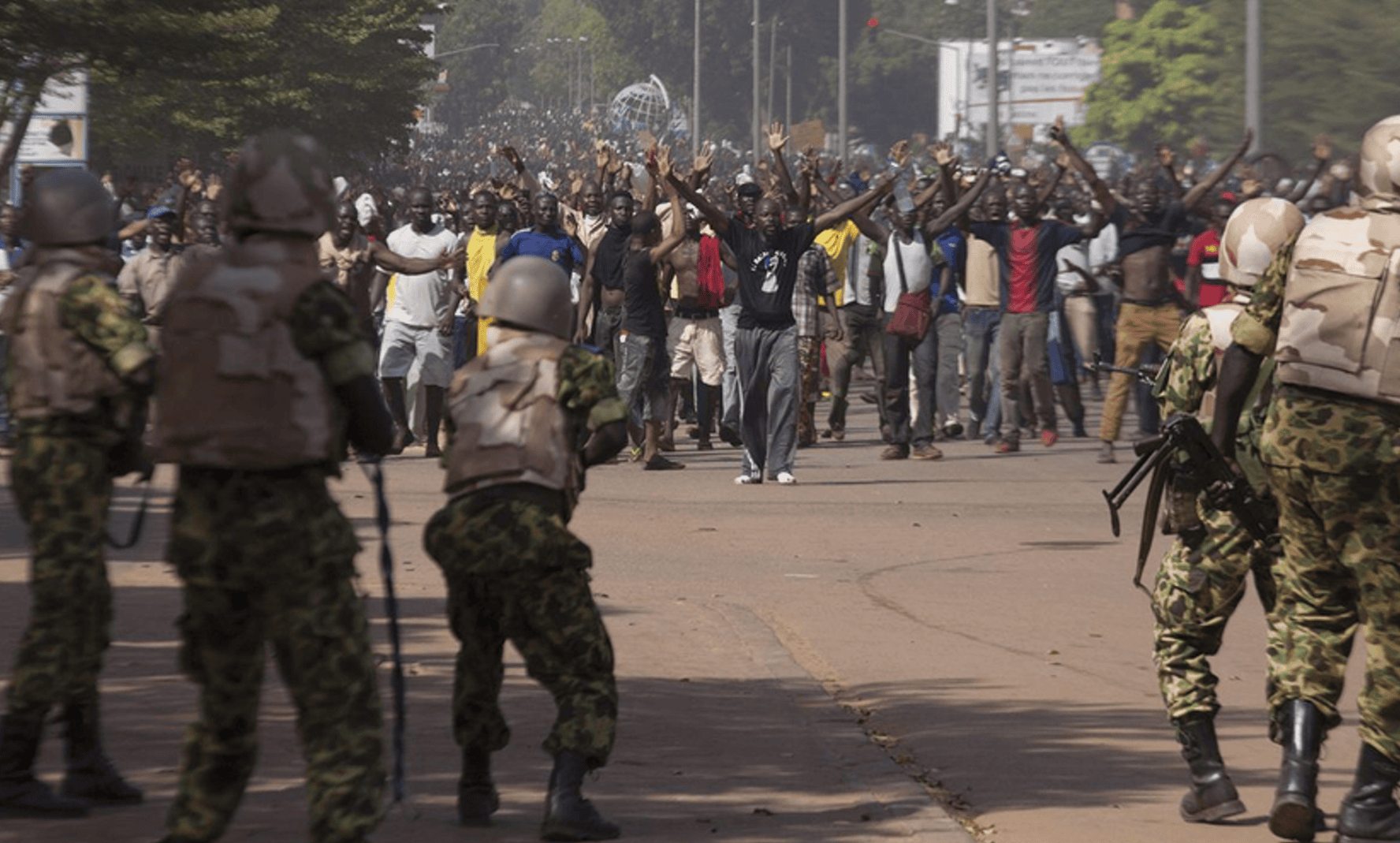 Soldiers attempt to stop protesters in Ouagadougou, Burkina Faso, on October 30, 2014